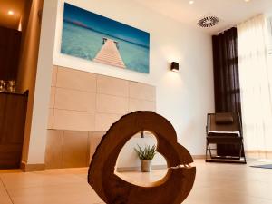 a living room with a wooden circle on the floor at Hotel Sachsenross in Nörten-Hardenberg