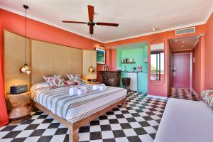 a bedroom with a large bed and a checkered floor at Cubanito Ibiza in San Antonio
