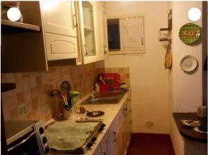 a kitchen with a sink and a stove top oven at Casale nel Borgo in Castiglione della Pescaia