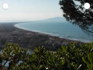 a view of a beach and the ocean at Casale nel Borgo in Castiglione della Pescaia +3 photos