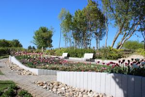 a garden with flowers and benches in a park at Villa Pippingsburg am Strand in Ahlbeck