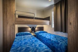 Postel nebo postele na pokoji v ubytování Camping Internazionale Etruria
