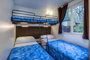Postel nebo postele na pokoji v ubytování Camping Internazionale Etruria