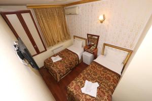 Postel nebo postele na pokoji v ubytování Meddusa Hotel