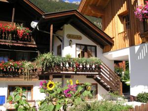 a building with flower boxes on the side of it at Müllerhof in Anterselva di Mezzo