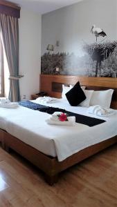 a bedroom with a large bed with a bird on the wall at Hotel Rural Sra De Pereiras in Vimioso