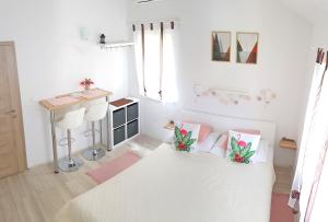 a white room with a table and some pillows at Hortenzia Apartments in Hvar