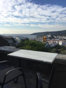 a white table and chairs on a balcony with a view at Es volca in Cadaqués