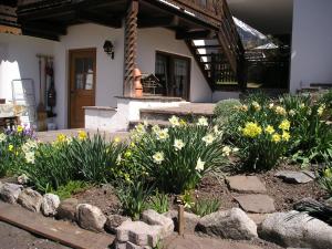 a garden of flowers in front of a house at Müllerhof in Anterselva di Mezzo