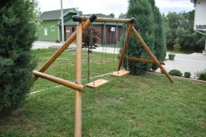a wooden swing set in a yard at Vila Edu in Končarevo