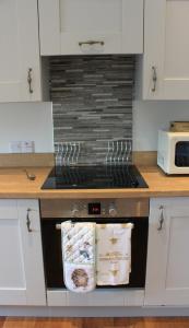 a stove top oven in a kitchen next to a counter at The Annex at Borlum House in Reay