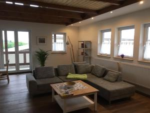 a living room with a couch and a table at Gut Fischer in Pomssen