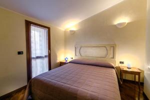 Posteľ alebo postele v izbe v ubytovaní Sirmio Apartments - Primavera Stay