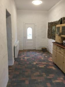 a room with a door and a tile floor at Gut Fischer in Pomssen