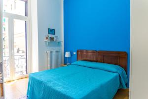 ein blaues Schlafzimmer mit einem Bett mit einer blauen Decke in der Unterkunft B&B Le Marinelle in Salerno