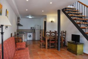 a living room with a staircase and a dining room at Las Casitas de los Mata in Landete