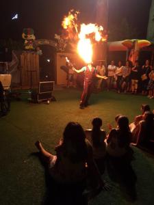 a man holding a fire show in front of a crowd at Hotel Mediterraneo in Qualiano