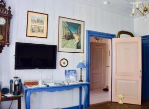 een woonkamer met een tv en een blauwe tafel bij Het Twiscker Huys in Twisk