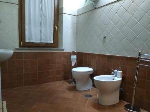 a bathroom with a toilet and a sink at Casa Vacanze Le Rose in Ariccia +35 photos