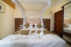 Postel nebo postele na pokoji v ubytování Spice Palace Hotel
