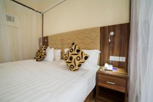 Postel nebo postele na pokoji v ubytování Spice Palace Hotel