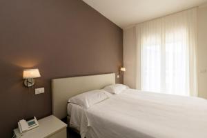 Postel nebo postele na pokoji v ubytování Hotel Saviola