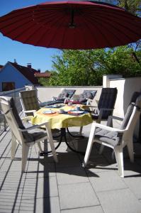 a table and chairs with an umbrella on a patio at Auf dem Berg in Malchow