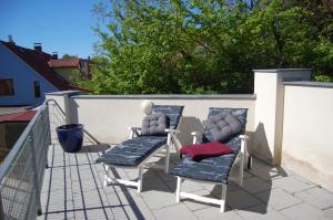 a pair of chairs sitting on a balcony at Auf dem Berg in Malchow