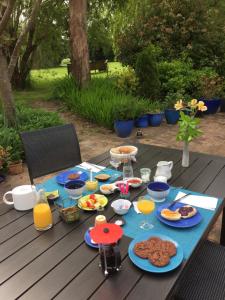 a picnic table with food and drinks on it at La Caillerie in Chauvé