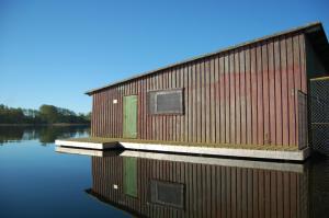 a building on a body of water at Auf dem Berg in Malchow