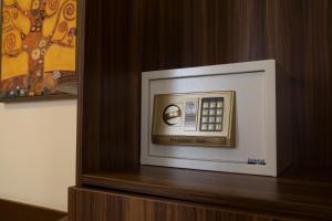 a white microwave oven sitting on top of a wooden shelf at Spice Palace Hotel in Zanzibar City
