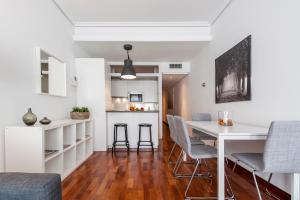 a kitchen and dining room with a white table and chairs at Retiro II in Madrid