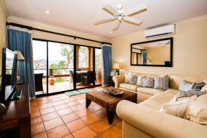 a living room with a couch and a tv at Flamingo Marina Resort 612 in Playa Flamingo