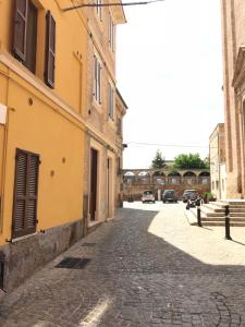 a cobblestone street in a city with buildings at Joseph Apartment in San Benedetto del Tronto