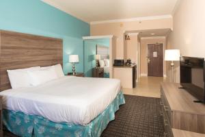
a hotel room with two beds and a television at Amelia Hotel at the Beach in Fernandina Beach

