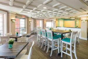 a dining room with wooden tables and chairs at Amelia Hotel at the Beach in Fernandina Beach