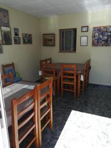 a dining room with a table and wooden chairs at Ca la Pilar in Poblenou del Delta