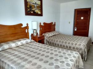 Llit o llits en una habitació de Hotel SPA Taninul