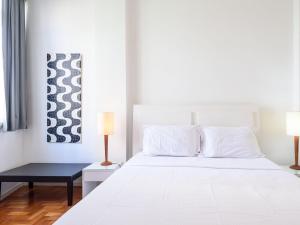 um quarto com uma cama branca e uma mesa preta em Amplo 3Qtos a 200m da Praia de Ipanema | BC 33/502 no Rio de Janeiro