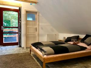 a bedroom with a bed and a window and a door at Guest House K74 in Jablonné v Podještědí