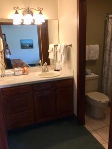 a bathroom with a sink and a toilet and a mirror at Hilltop Inn Broomfield Denver in Broomfield