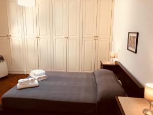 a bedroom with a bed with two towels on it at Palazzo Rota Guesthouse in Naples