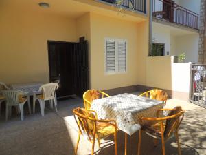 a patio with a table and chairs and a table at Guest House Jelena in Budva