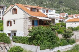 a white house with orange roof at Villaina in Komiža