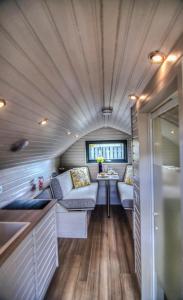 a living room with a couch and a table in a trailer at Foxy's Den Dornoch in Dornoch