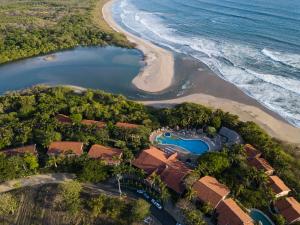 an aerial view of a resort next to the beach at Occidental Tamarindo - All Inclusive in Tamarindo