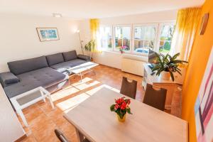 a living room with a table and a couch at Haus Jasmund in Binz