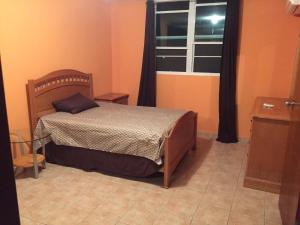 a small bedroom with a bed and a window at Comfortable Apartment in Boqueron - cash only in Cabo Rojo