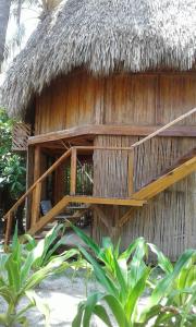 a straw hut with a thatched roof at Hotel Tortuga Village in La Herradura