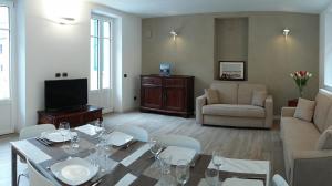 a living room with a table and a couch at Appartamento i Tulipani - 1 in Griante Cadenabbia